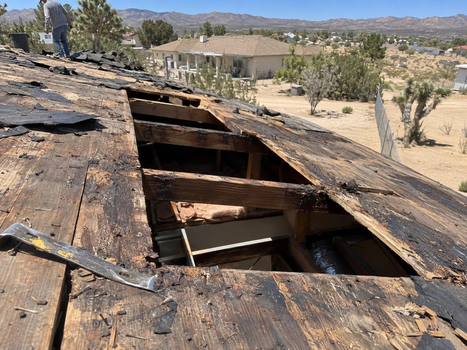 Rotten roof decking cut out, rafters showing through the openings
