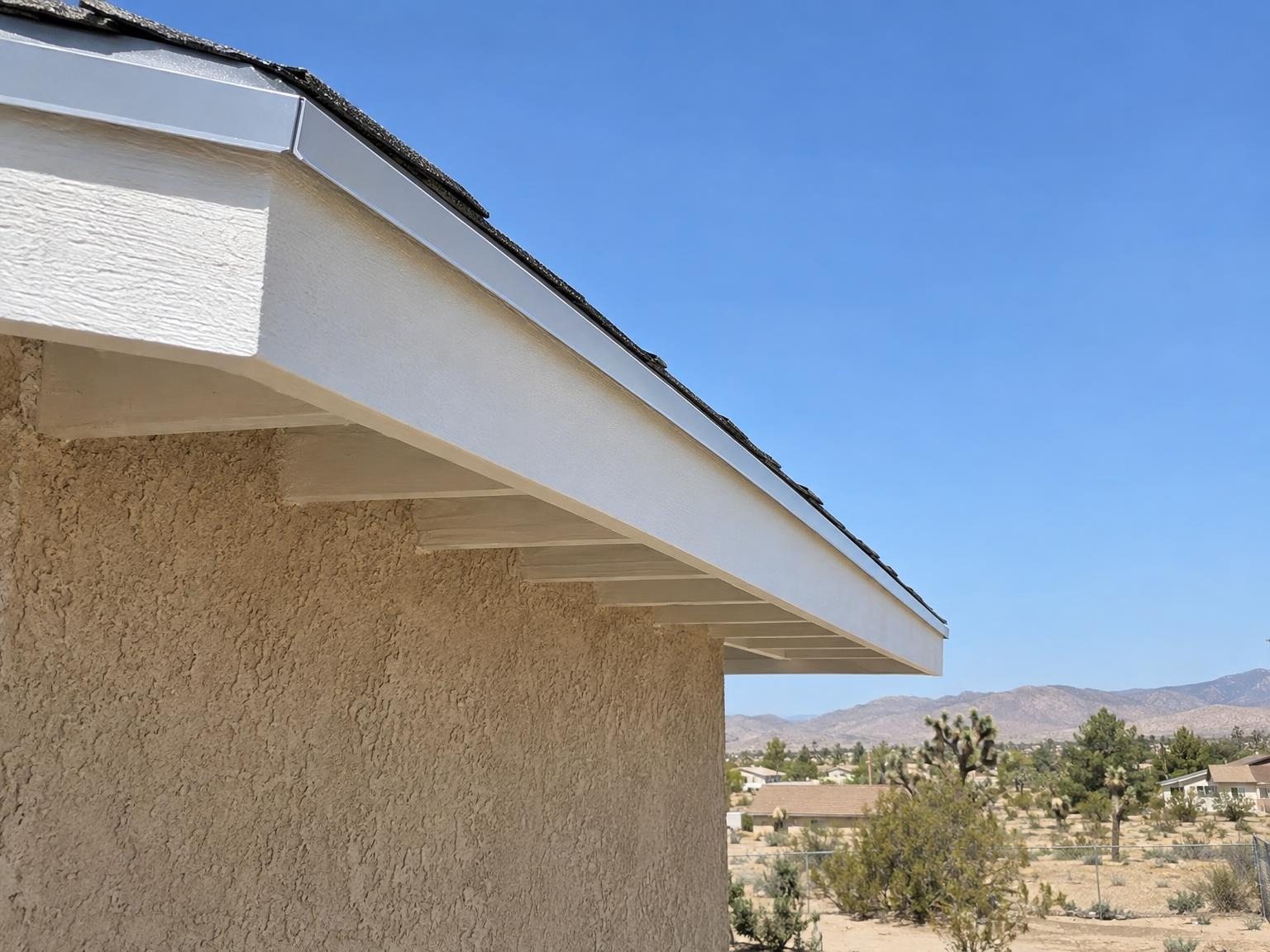 New white fascia with metal drip edge along the eave