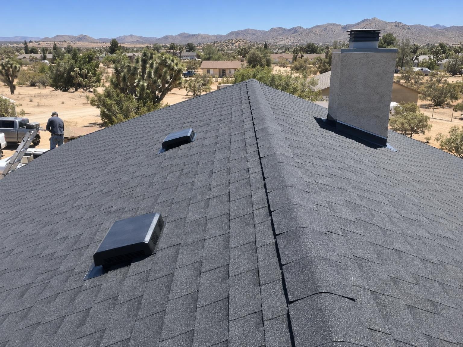 After: new charcoal shingle roof with vents