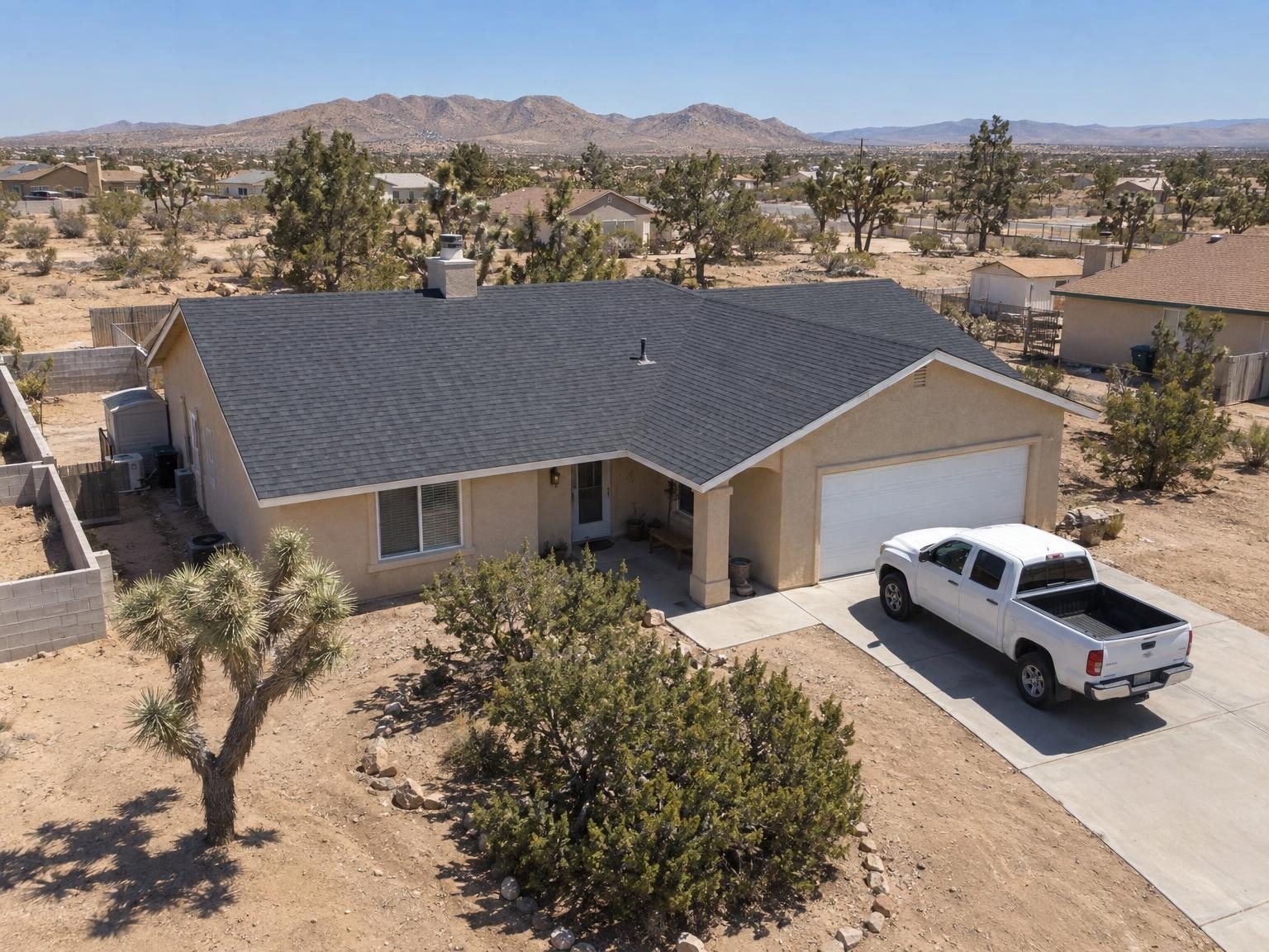 Drone view of the finished charcoal roof with the crew’s truck in the driveway