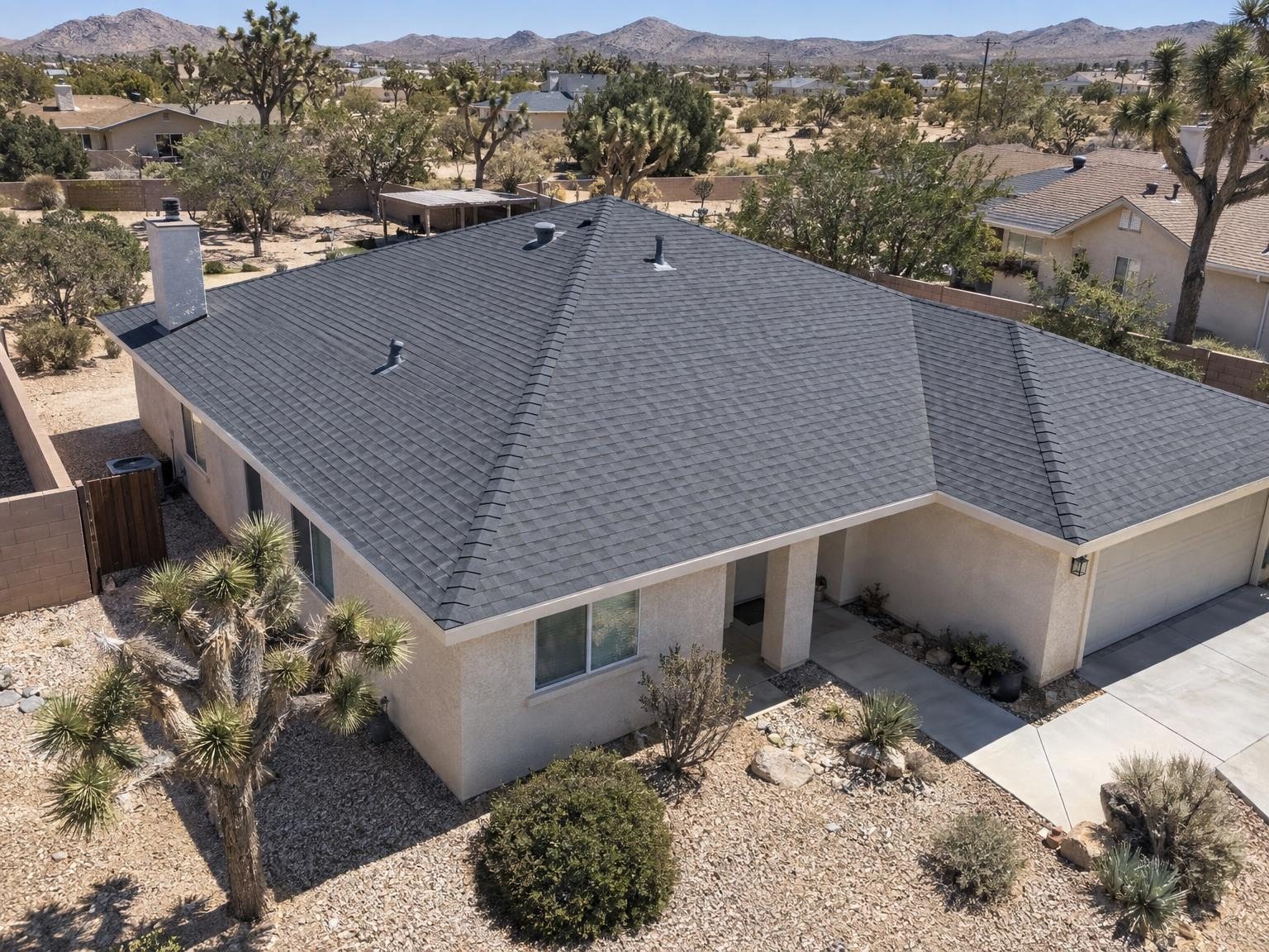 Drone view of a finished charcoal shingle re-roof on a High Desert home